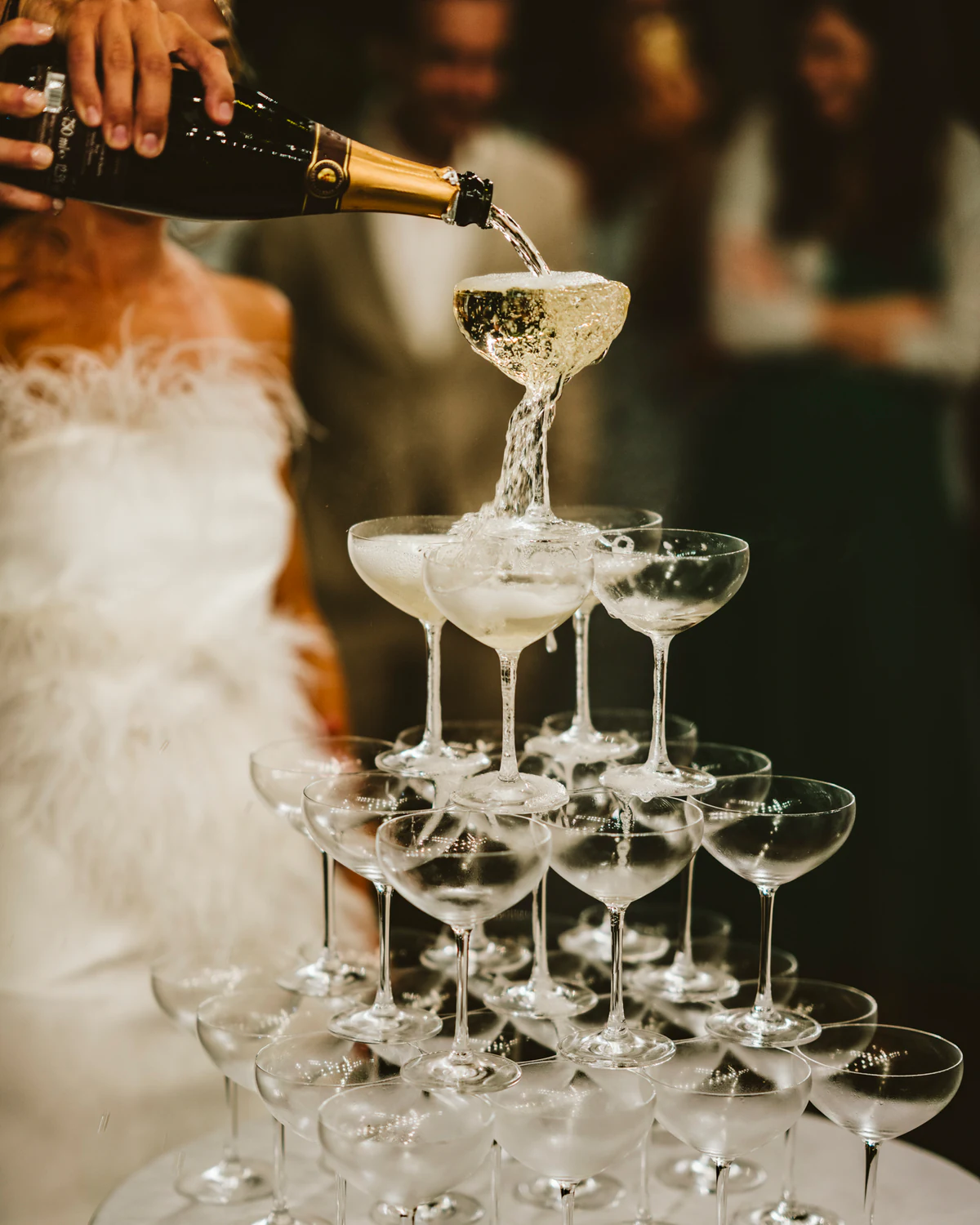 Champagne poured over a tower of coupes