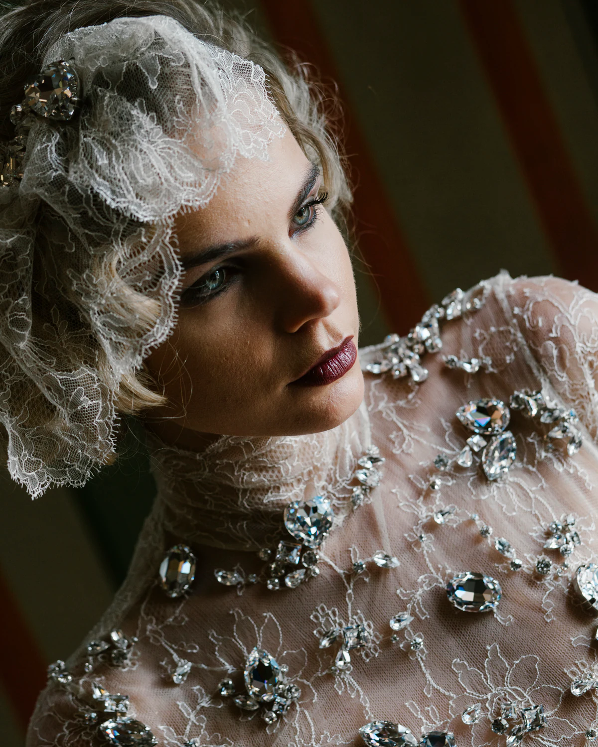A woman with pale curls in a jewelled gown