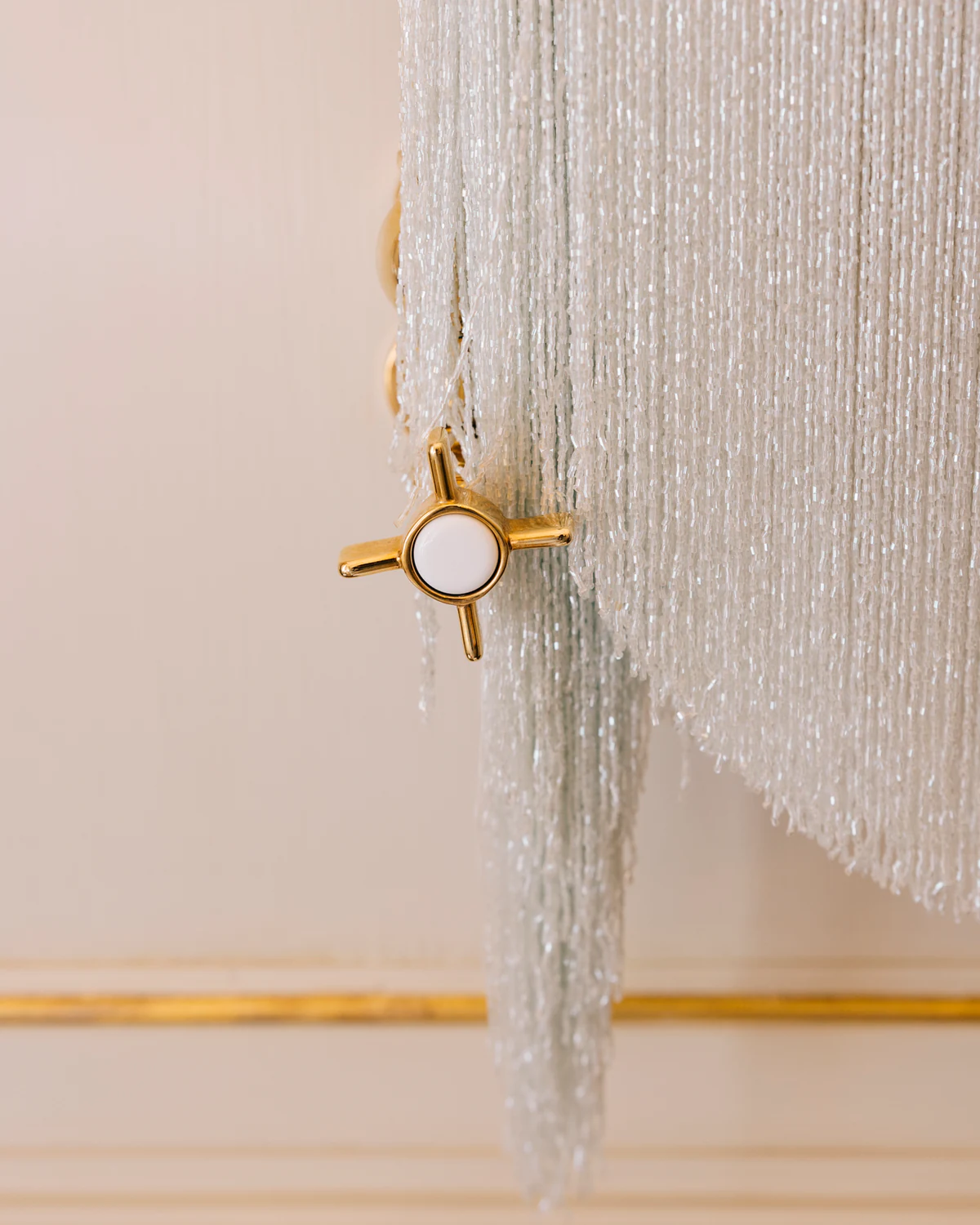 A curtain of crystal strands with a gold star