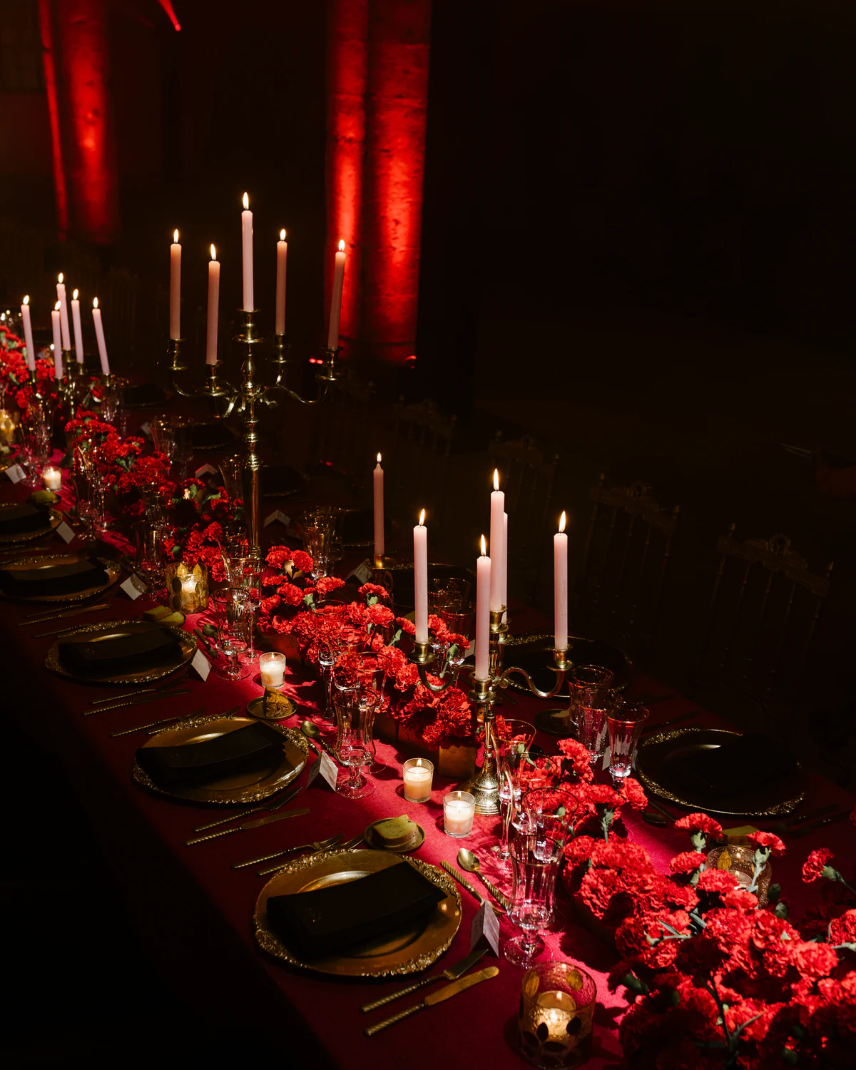 The banquet table, red flowers and lit candles