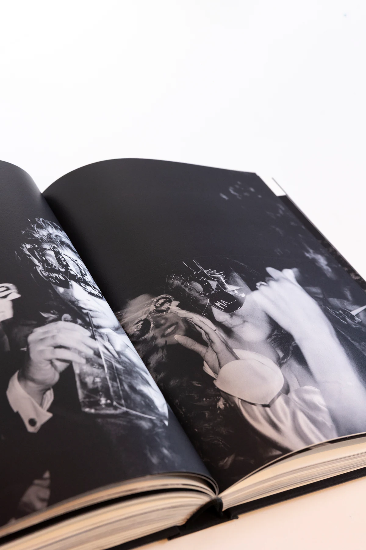 The Editorial Album open on a black and white photograph of the party