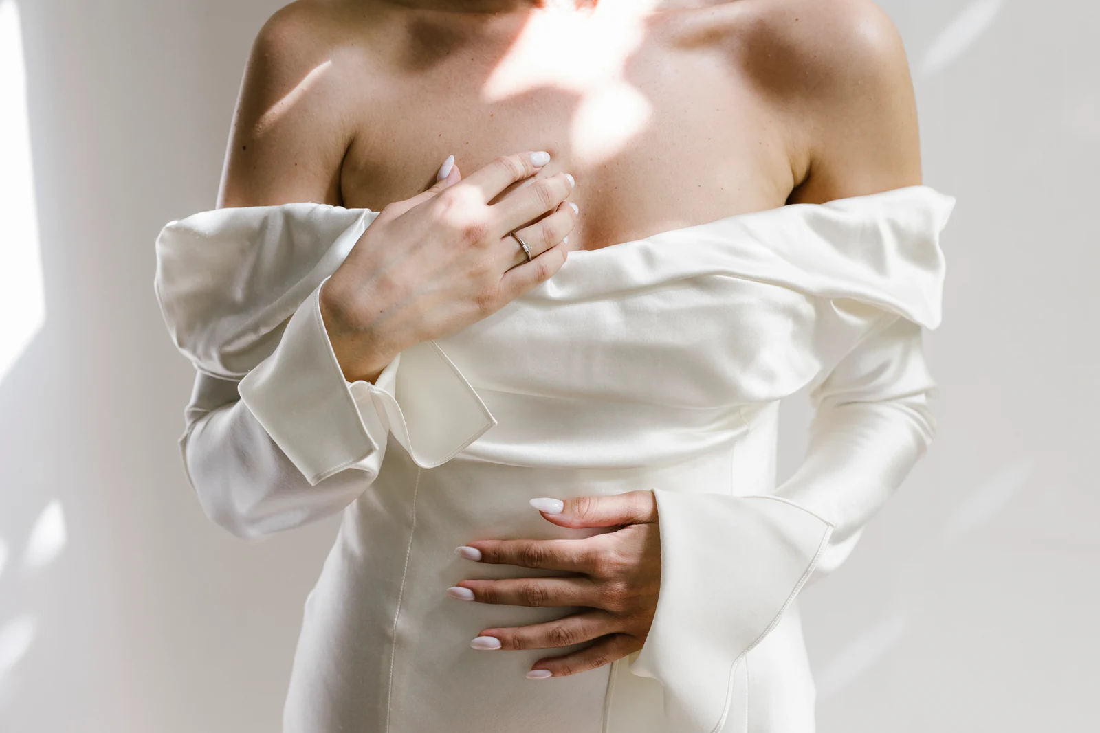 The bride's hands resting on her dress