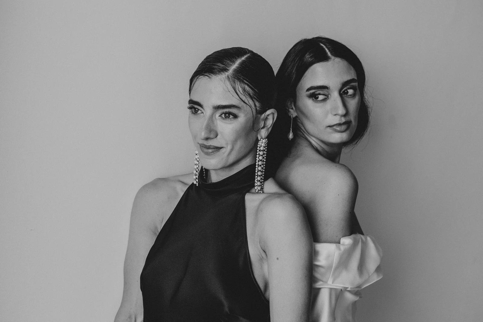 The bride and a friend in a black dress, side by side