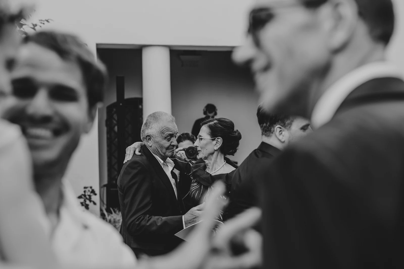 Guests laughing and greeting each other after the ceremony