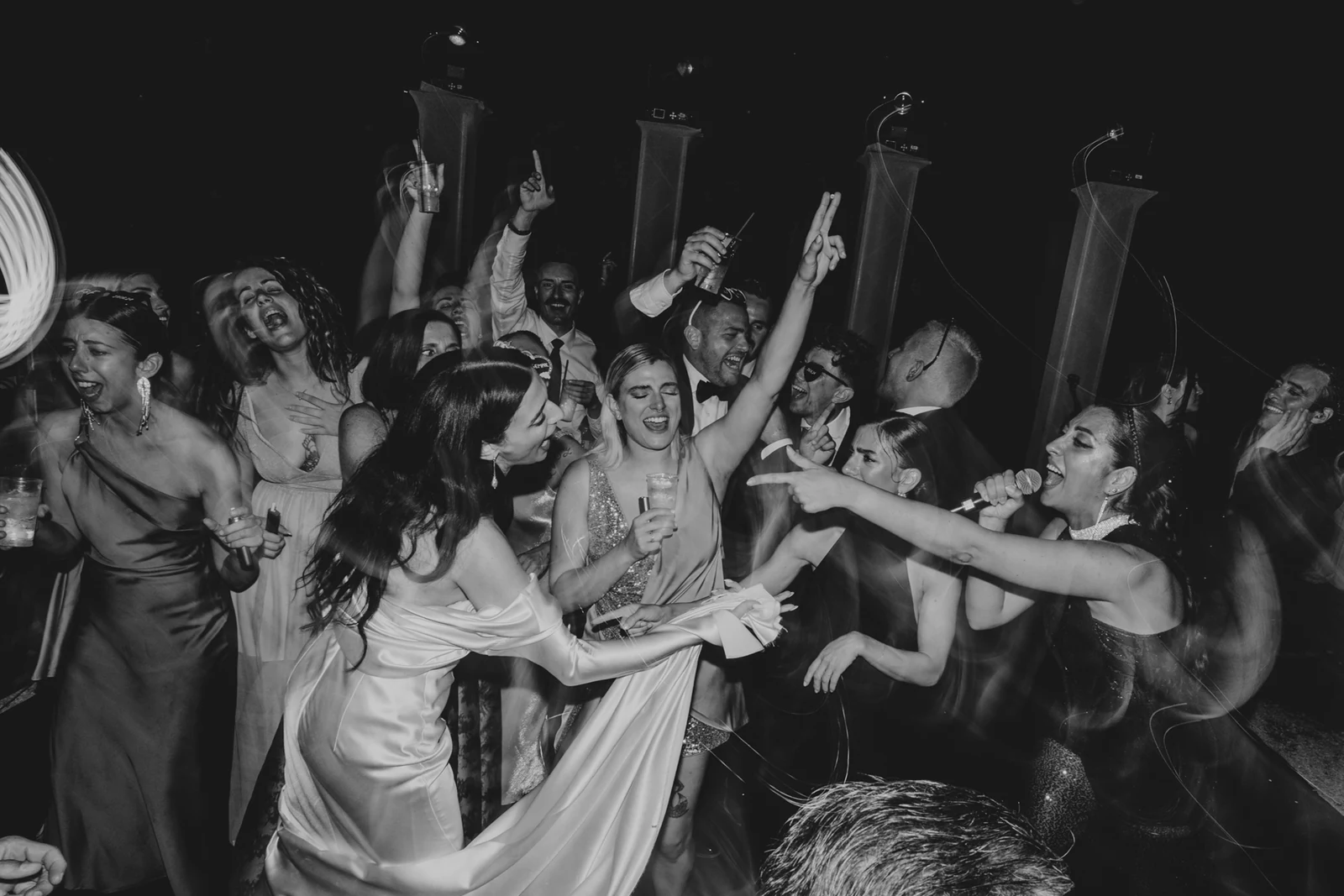 The dance floor at night, guests with their arms raised