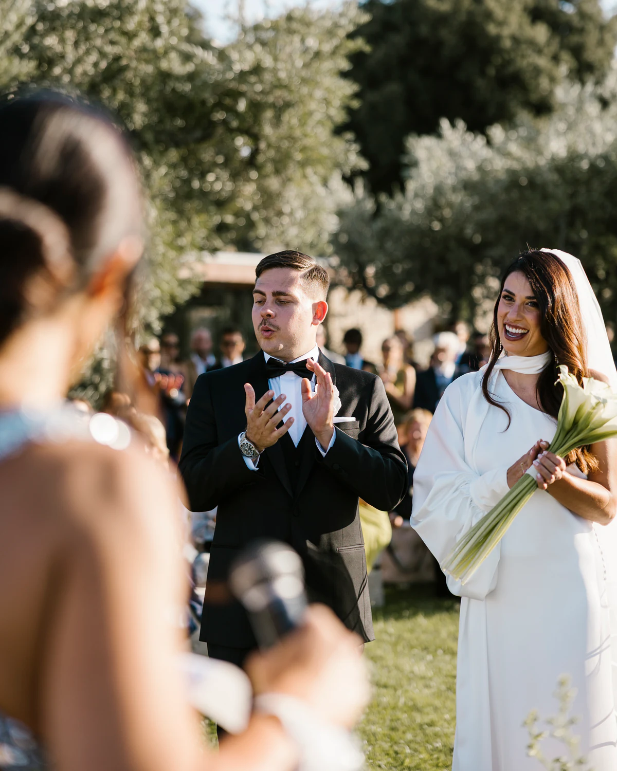 The couple during the ceremony, a friend reading at the microphone