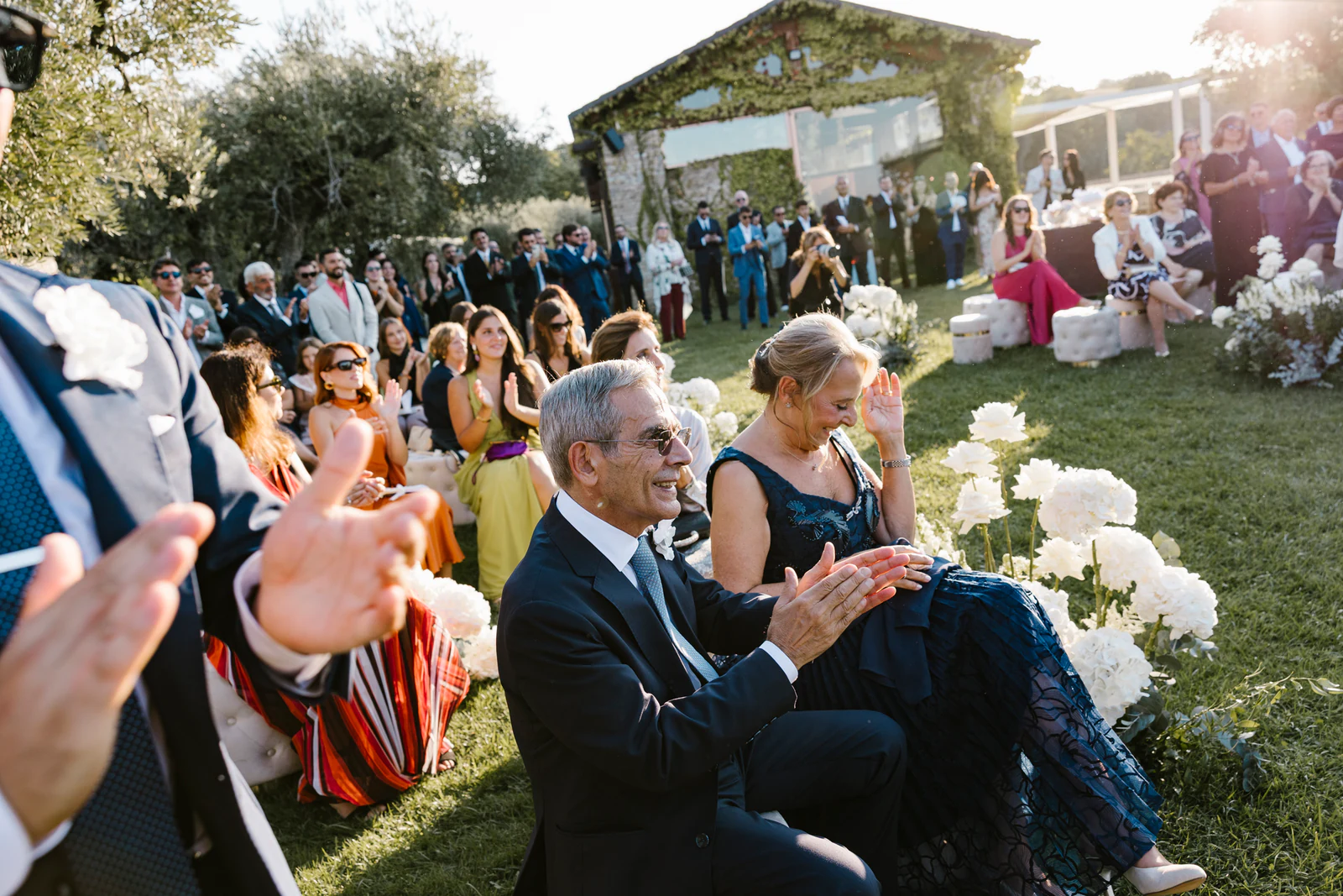 Guests applauding among the white flowers