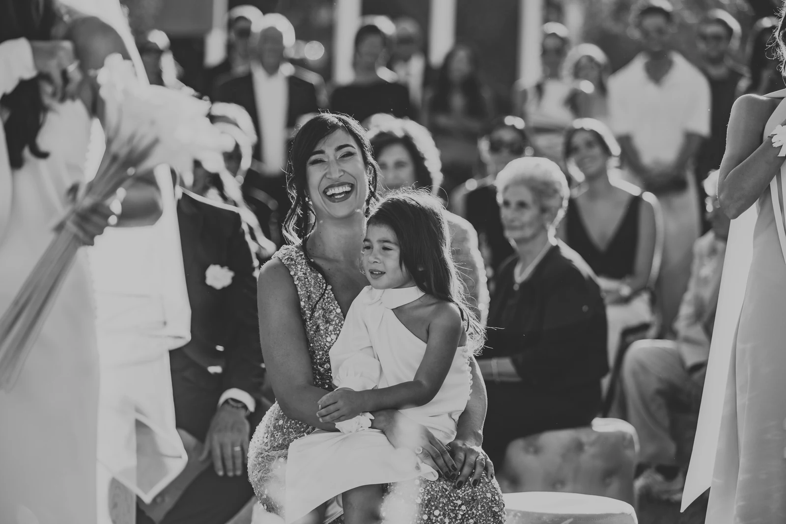 A guest laughing with a little girl on her lap