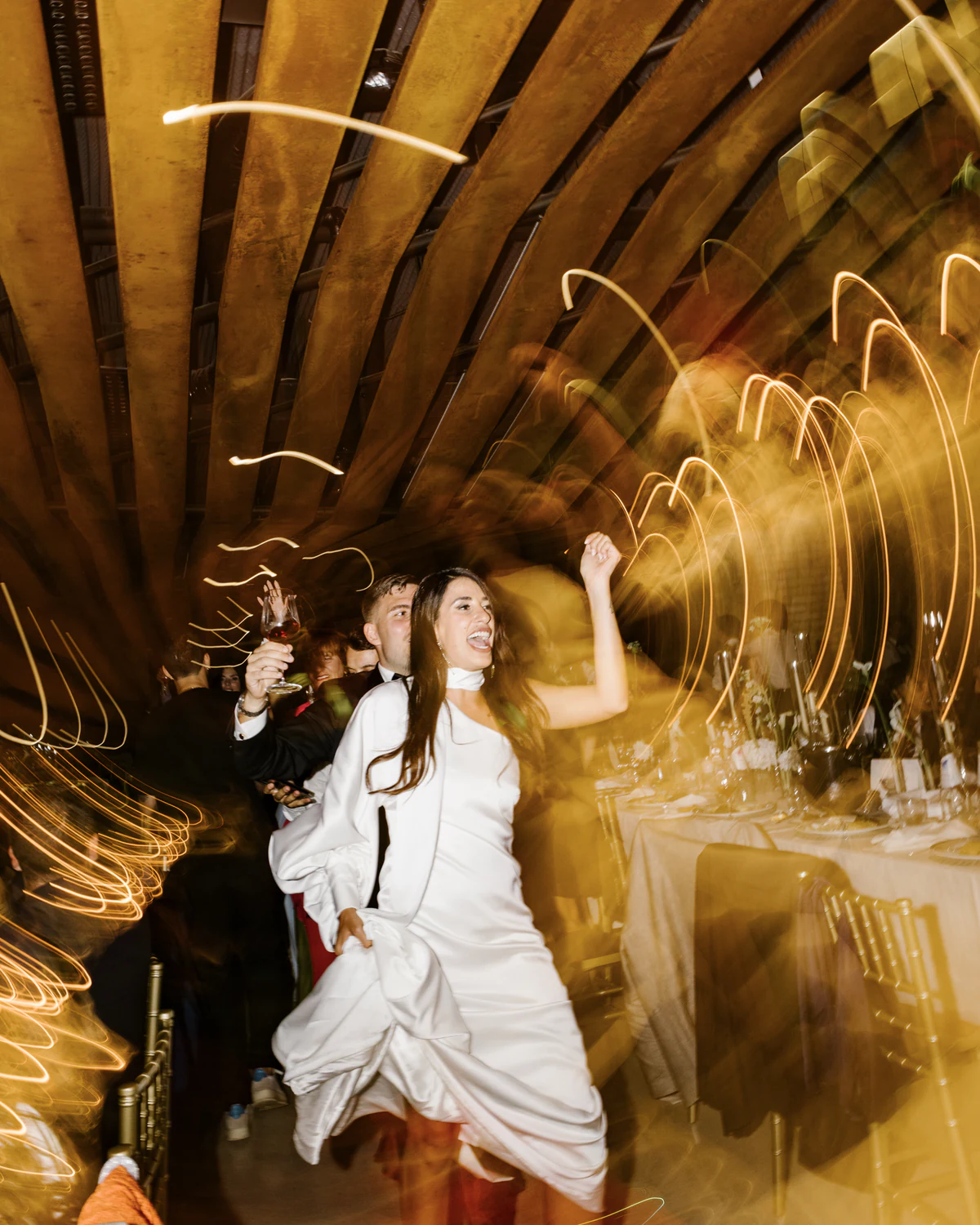 The bride dancing, surrounded by light