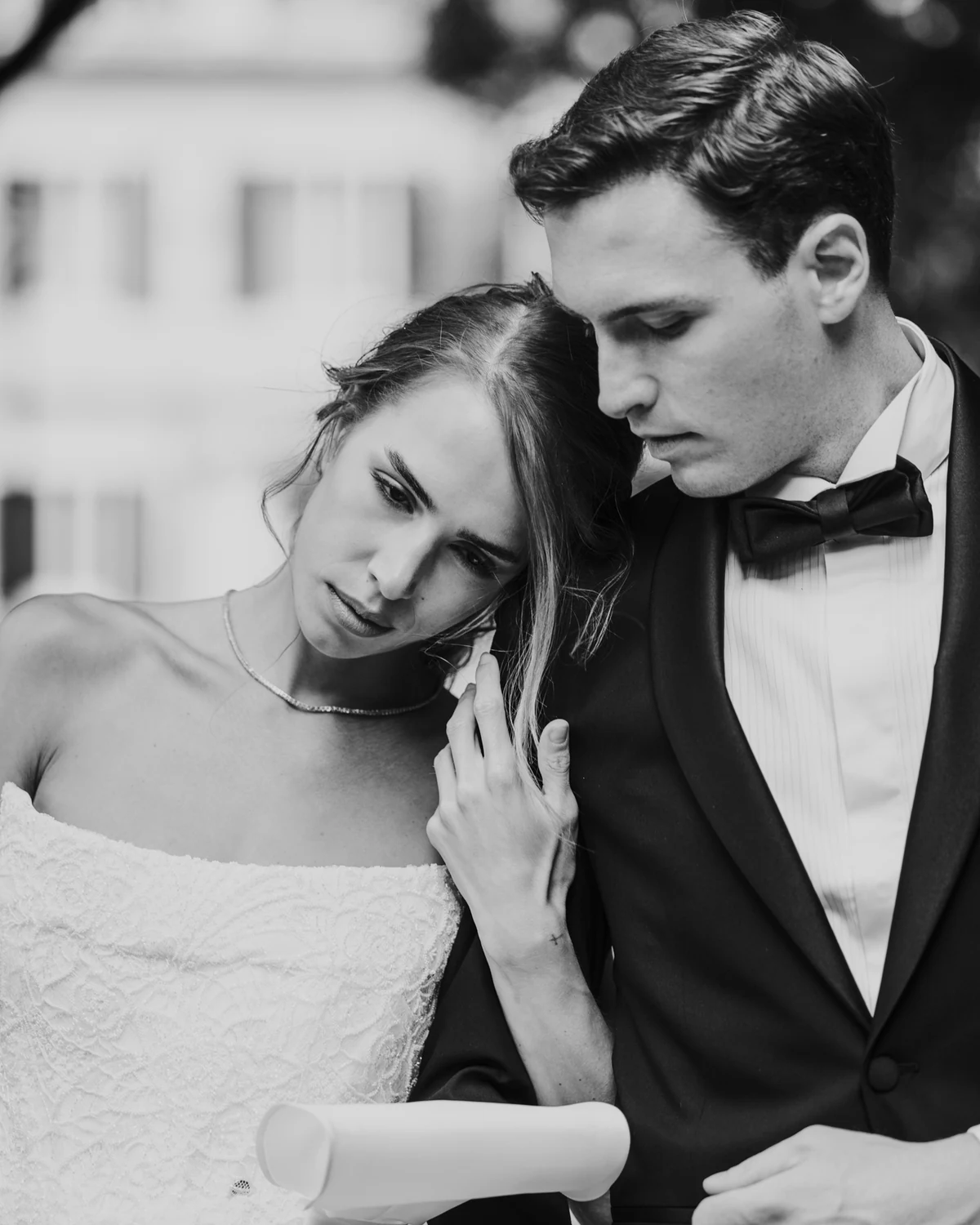 The bride resting her head on the groom's shoulder