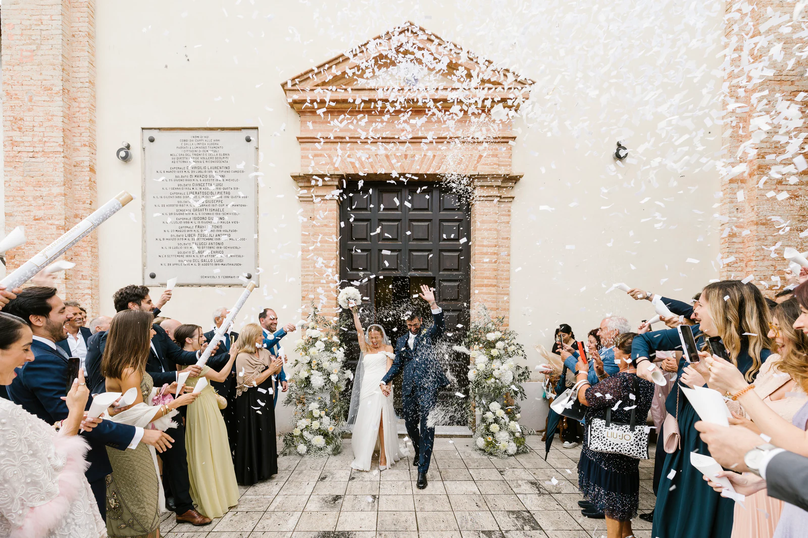 The couple leaving the church under a shower of confetti