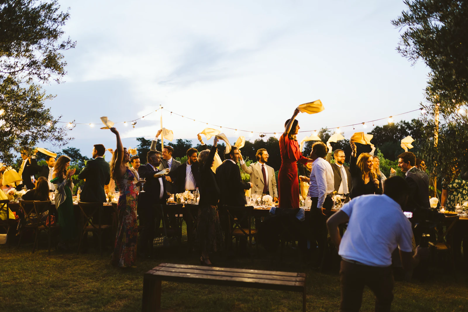 Guests waving yellow napkins in the air