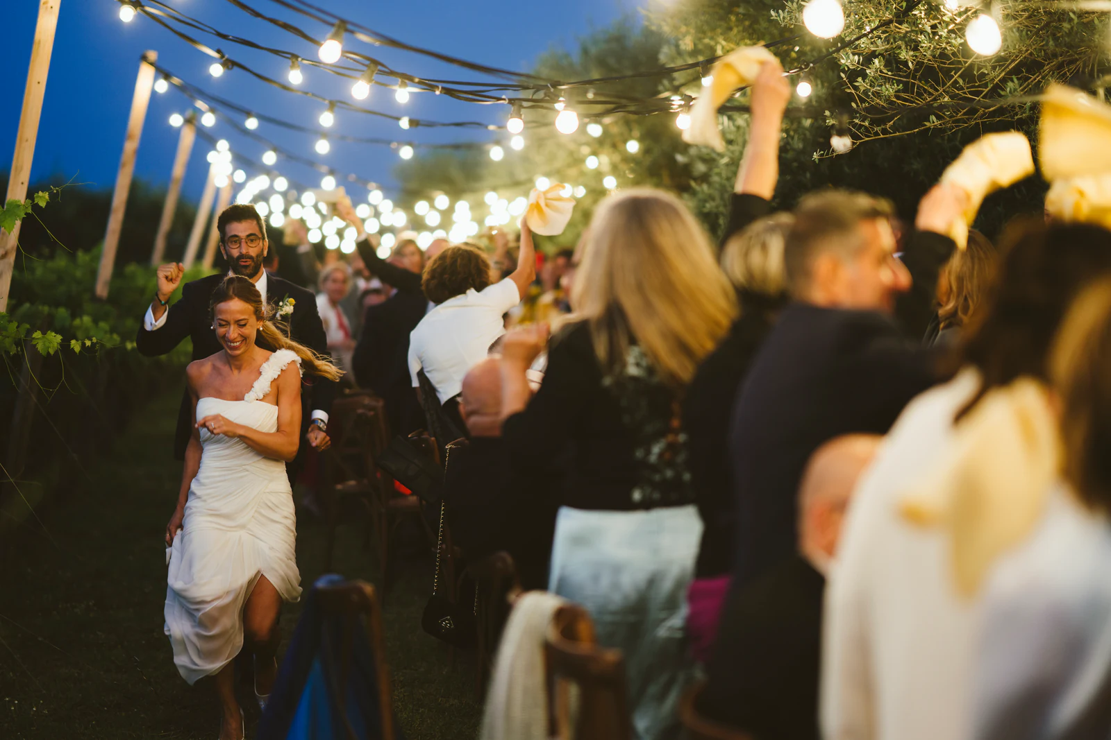 The bride dancing among the guests under the lights