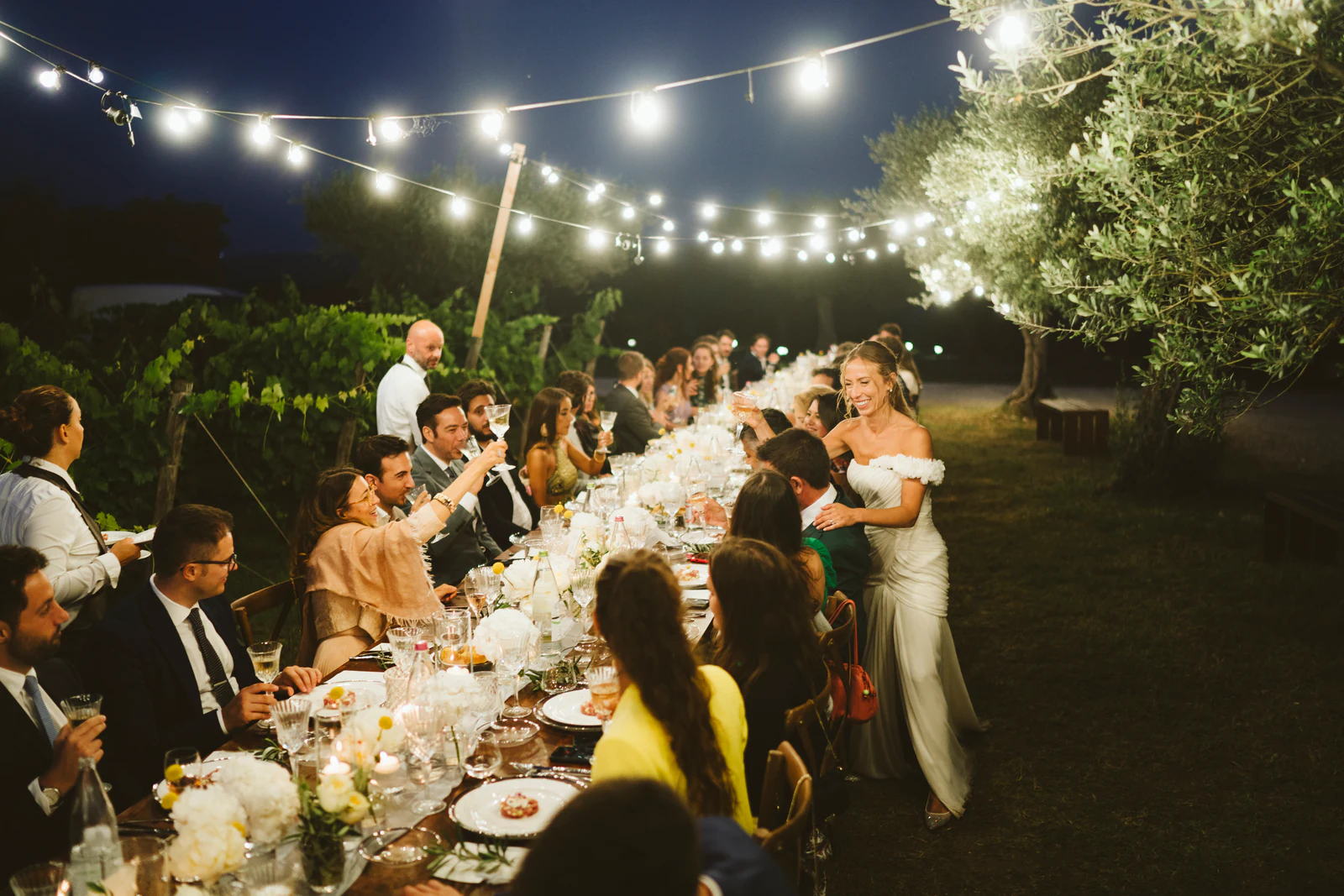 The long table at night under strings of lights