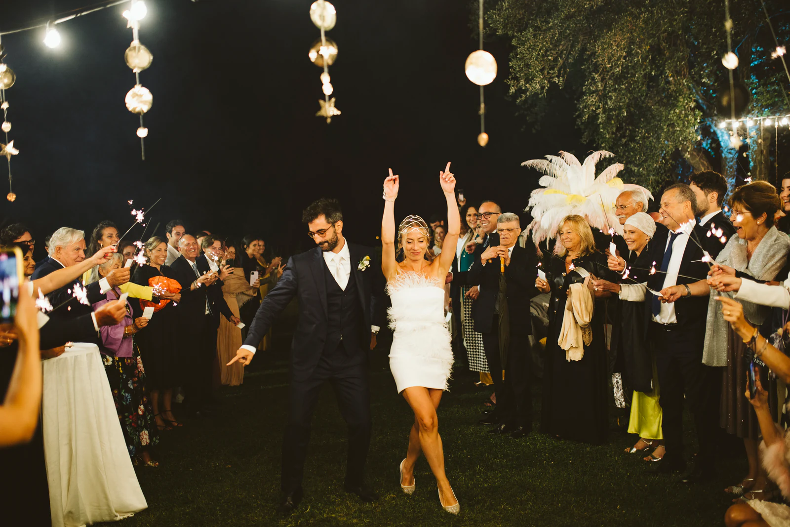 The couple dancing among the guests at night