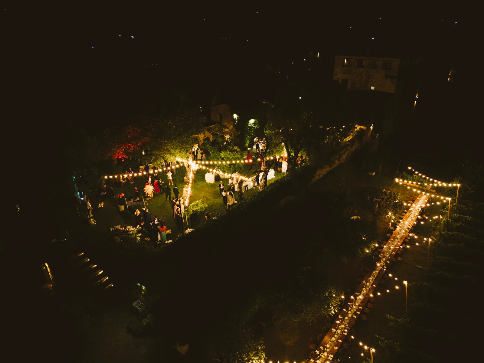 The party seen from above at night, a garden of lights