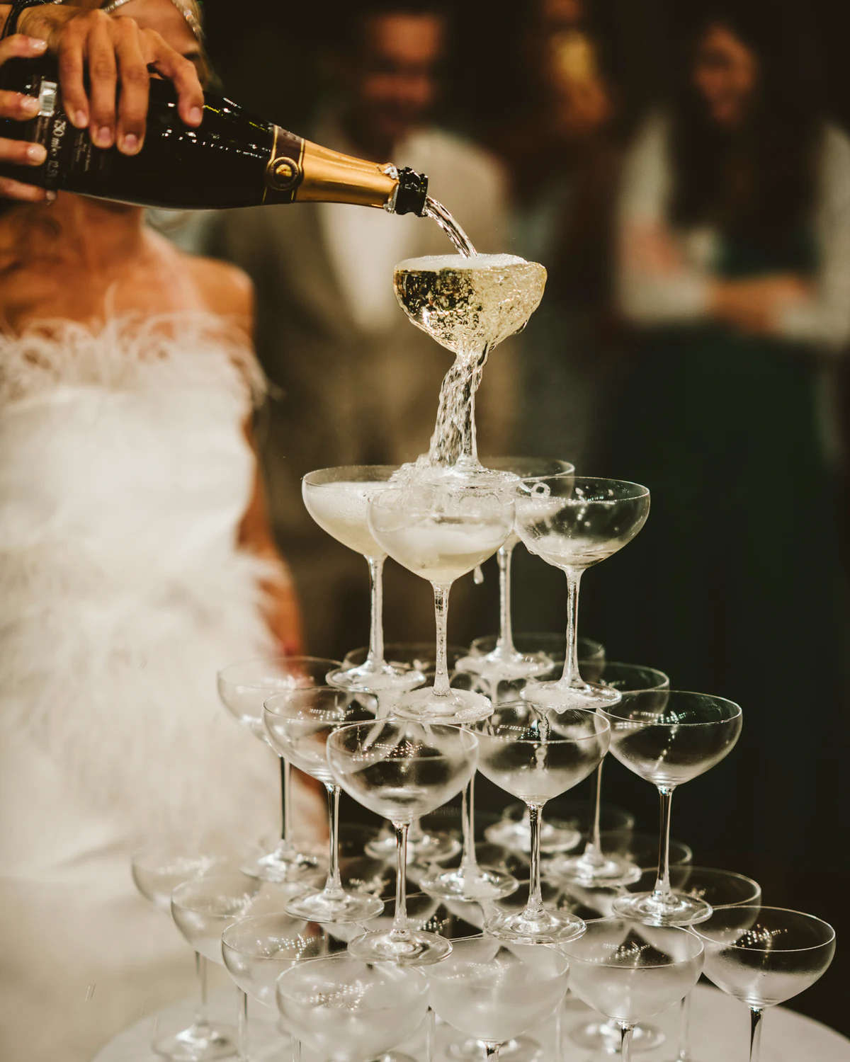 Champagne poured into a tower of glasses